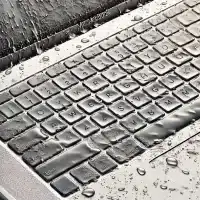 Photo of a MacBook keyboard with visible water damage and in need of repair.