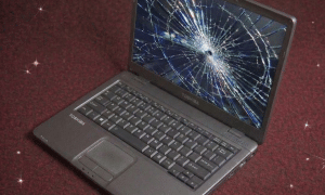 A premium replacement Full HD LED display panel for a Toshiba Satellite and Dynabook laptop, positioned on a solid light pink background for Atlantis repair services.