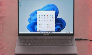 A premium replacement DC power jack with wire harness for an Asus ZenBook laptop, displayed on a solid light pink background for Atlantis UK-wide repair services.