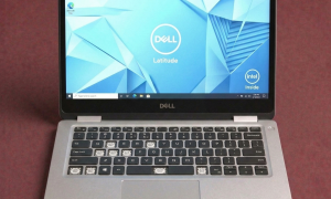 A premium replacement backlit QWERTY keyboard assembly for a Dell laptop, shown on a solid light pink background for Atlantis repair services.