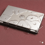 Detailed internal view of a Dell laptop motherboard showing specialist corrosion removal from a spilled liquid, positioned on a solid light pink background for Atlantis repair services.