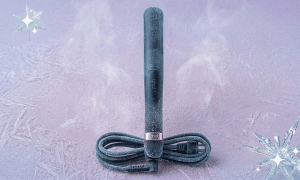 A professional GHD circuit board repair and replacement ceramic heating element, displayed on a solid light pink background for Atlantis UK-wide hair straightener repair services.