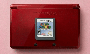 A premium replacement 3DS game card slot with 17-pin gold contacts for a Nintendo 3DS XL, displayed on a solid light pink background for Atlantis UK-wide console repair services.