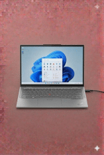 A professional technician replacing a Lenovo ThinkPad DC power jack on a motherboard, displayed on a solid light pink background for Atlantis UK-wide repair services.