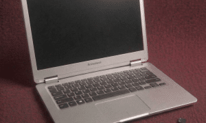 A premium replacement QWERTY keyboard assembly for a Lenovo laptop, including the signature red TrackPoint for ThinkPad models, shown on a solid light pink background for Atlantis repair services.