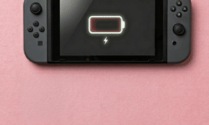 A premium high-capacity 4310mAh replacement lithium-ion battery for a Nintendo Switch, displayed on a solid light pink background for Atlantis UK-wide console repair services.