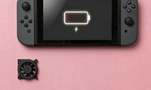 A premium high-velocity replacement internal cooling fan for a Nintendo Switch, displayed on a solid light pink background for Atlantis UK-wide console repair services.