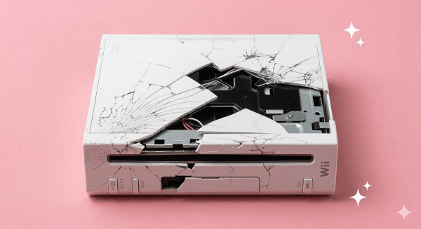A premium high-gloss white replacement outer shell housing for a Nintendo Wii console, displayed on a solid light pink background for Atlantis UK-wide restoration services.