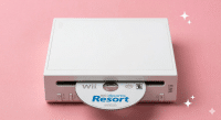 A premium replacement optical disc drive laser and motor assembly for a Nintendo Wii, displayed on a solid light pink background for Atlantis UK-wide console repair services.