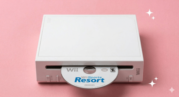 A premium replacement optical disc drive laser and motor assembly for a Nintendo Wii, displayed on a solid light pink background for Atlantis UK-wide console repair services.