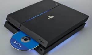 Professional 1:1 square studio photograph of a black PlayStation 4 console with a game disc half inserted into the drive, set against a solid light pink background for Atlantis console repair services.