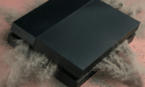 Close-up of a PlayStation 4 internal cooling fan and heat sink assembly, positioned on a solid light pink background for Atlantis repair services.