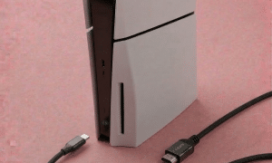 A professional micro-soldering repair of a damaged PS5 HDMI 2.1 port, displayed on a solid light pink background for Atlantis UK-wide console repair services.