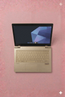A Toshiba laptop being professionally serviced at the Atlantis workshop in Canterbury, shown on a solid light pink background for UK-wide mail-in repair services.
