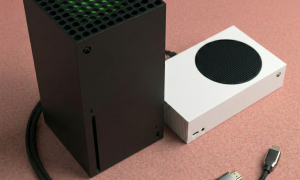 Close-up of a high-precision replacement HDMI 2.1 port for the Xbox Series X and Series S consoles, positioned on a solid light pink background for Atlantis repair services.