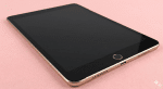 A high-quality replacement internal home button flex cable and power/volume button assembly for an iPad 6th and 7th Gen, shown on a solid light pink background for Atlantis repair services.
