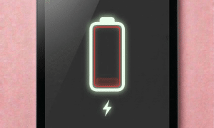 A premium high-capacity replacement battery for an iPad Mini, displayed on a solid light pink background for Atlantis UK-wide battery repair services.