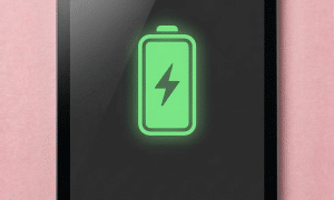 A premium replacement Lightning or USB-C charging port flex cable for an iPad Mini, displayed on a solid light pink background for Atlantis £80 repair services.