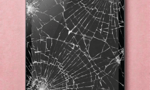 A premium replacement Retina display and glass digitiser assembly for an iPad Mini, shown on a solid light pink background for Atlantis repair services.