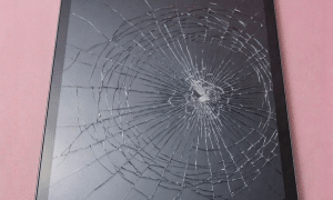 A premium replacement laminated Liquid Retina ProMotion display assembly for an iPad Pro 11-inch or 12.9-inch, shown on a solid light pink background for Atlantis repair services.