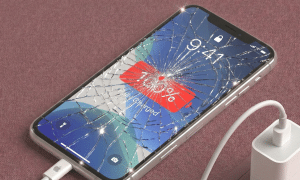 Close-up of a premium replacement Super Retina XDR OLED display panel for the iPhone 11 Pro Max, positioned on a solid light pink background for Atlantis repair services.