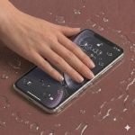 Detailed internal view of an iPhone 11 logic board showing specialist corrosion removal and ultrasonic cleaning, positioned on a solid light pink background for Atlantis repair services.