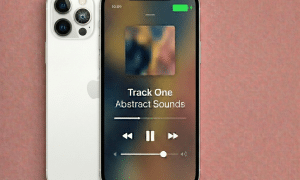 Close-up of the advanced dual and triple-lens camera systems on an Apple iPhone 12, Mini, Pro, and Pro Max, set against a solid light pink background for Atlantis repair services.