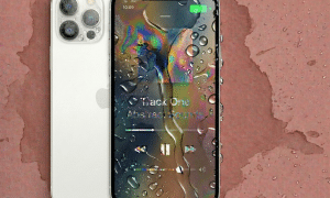 Close-up of the internal logic board and water-resistant gaskets of an Apple iPhone 12, Mini, Pro, or Pro Max, positioned on a solid light pink background for Atlantis repair services.