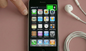 Close-up of a replacement 30-pin charging port and dock connector assembly for the iPhone 3G and 3GS, positioned on a solid light pink background for Atlantis repair services.