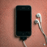 Close-up of a replacement headphone jack flex cable assembly for the iPhone 3G and 3GS, including the volume and mute switch contacts, on a solid light pink background for Atlantis.