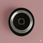 Close-up of the circular Home Button on an Apple iPhone 4, positioned on a solid light pink background for Atlantis repair services.