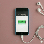 Close-up of the Lightning charging port and dock connector assembly for an iPhone 5, 5S, 5C, and 5SE, positioned on a solid light pink background for Atlantis repair services.