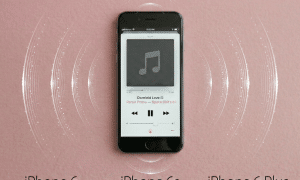 Close-up of the speaker grilles on the bottom edge of an Apple iPhone 6 and 6S series handset, set against a solid light pink background for Atlantis repair services.