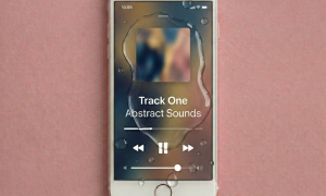 Close-up of the internal logic board and water-resistant seals of an Apple iPhone 7 and 8 Plus, positioned on a solid light pink background for Atlantis repair services.