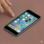 Close-up of a high-resolution replacement rear camera module with optical image stabilisation for the iPhone 7, 8, and SE series, positioned on a solid light pink background for Atlantis repair services.