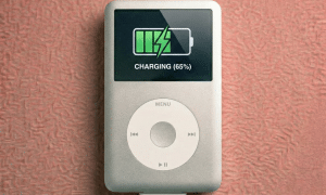 Close-up of a high-quality 30-pin replacement dock connector and charging port for the Apple iPod Classic, positioned on a solid light pink background for Atlantis repair services.