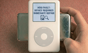 Close-up of a 1.8-inch internal mechanical hard drive and high-performance flash storage adapter for the Apple iPod Classic, positioned on a solid light pink background for Atlantis repair services.