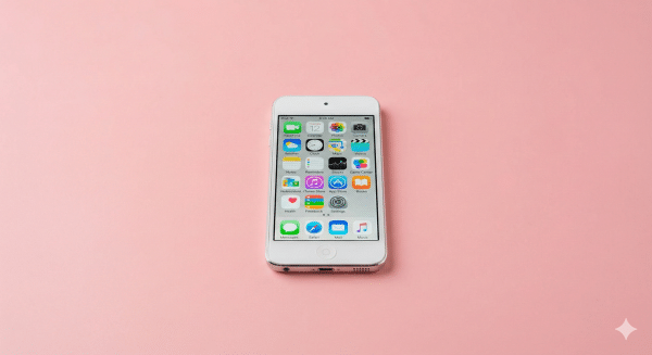 Professional 1:1 square studio photograph showing the bottom edge of a silver iPod Touch, focusing on the Lightning charging port against a solid light pink background for Atlantis repair services.