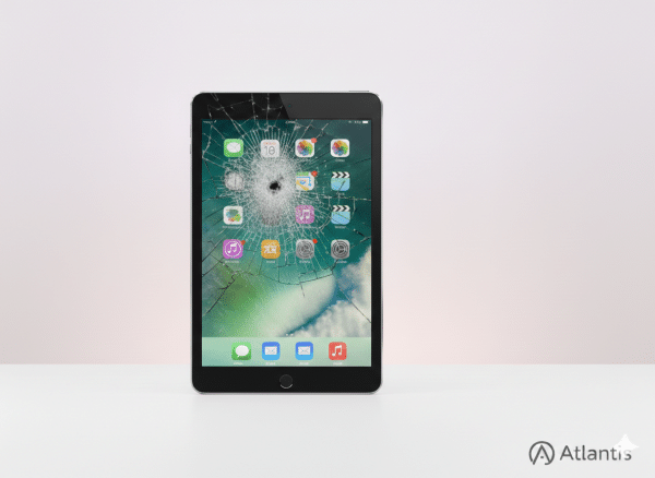 iPad 5 with a badly cracked glass screen on a clean white background, ready for an Atlantis professional screen repair