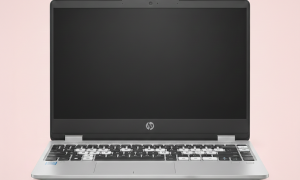 Professional 1:1 square studio photograph of a silver HP laptop with several missing keys on the keyboard and loose keycaps resting on the light pink surface for Atlantis keyboard repair services