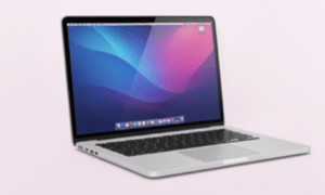A sleek, silver Apple MacBook laptop open and viewed from a side angle, displaying a vibrant blue and purple macOS wallpaper on a high-definition screen.